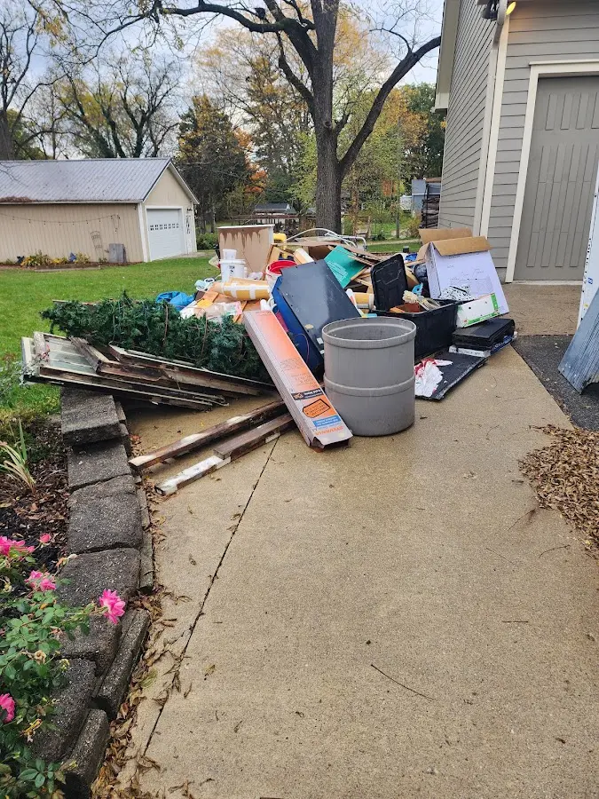 Dumpster being loaded with debris for Estate Cleanout Dumpster Rental in North Wildwood